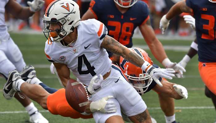 Virginia Cavaliers receiver Billy Kemp (3) fumbles the ball on a punt return on a tackle by Illinois Fighting Illini defensive back Sydney Brown (30) in the first half at Memorial Stadium.